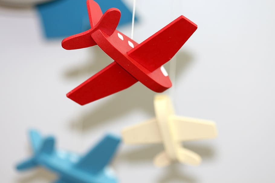 shallow focus photography of red wooden airplane hanging decoration HD wallpaper
