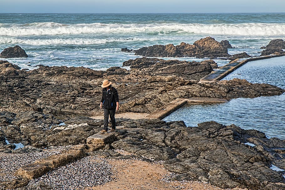 person standing on rock, alone, beach, rocks, seaside, ocean HD wallpaper