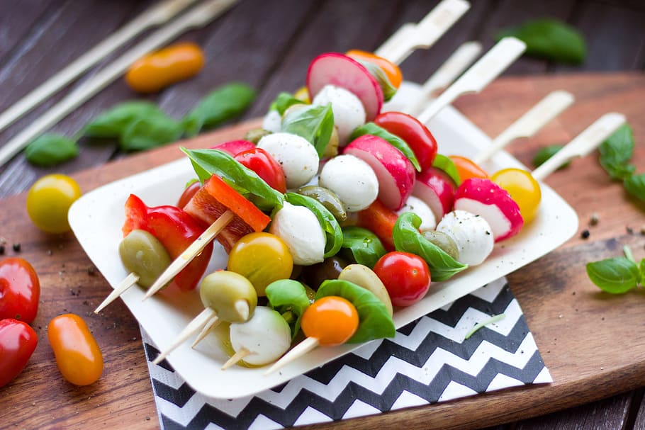 assorted fruits and vegetables on stick, spit, antipasti, tomatoes