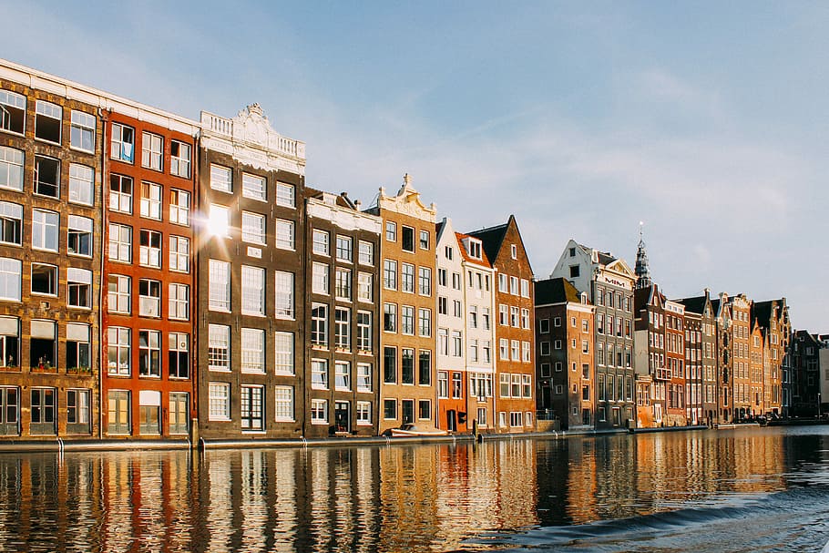 assorted-color buildings beside body of water, multicolored building beside body of water HD wallpaper