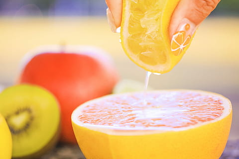 person holding a lemon squeezing, fruit, food, freshness, juice HD wallpaper