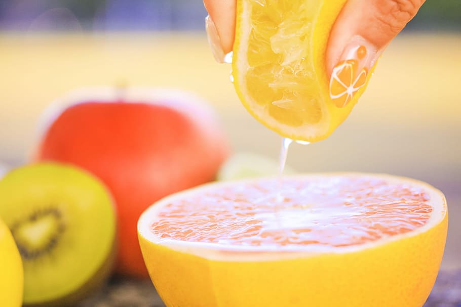 person holding a lemon squeezing, fruit, food, freshness, juice HD wallpaper