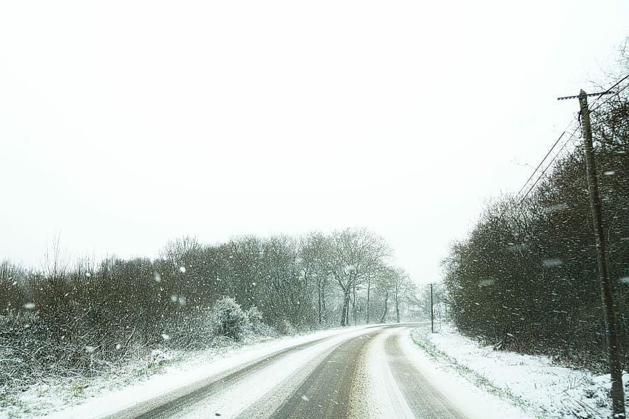 empty winding road surrounded by snow, asphalt road covered with snow HD wallpaper