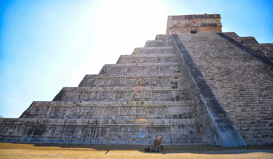 person sitting on grass field in front on gray concrete pyramid, person sitting on edge of Mayan ruins, HD wallpaper