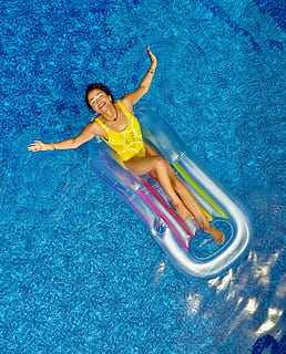 woman riding on plastic floating buoy on body of water, woman wearing yellow monokini on inflatable boat on pool HD wallpaper