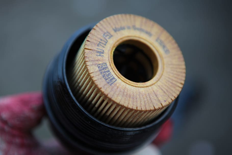 person holding brown and black filter, Engine Oil, Oil Filter HD wallpaper