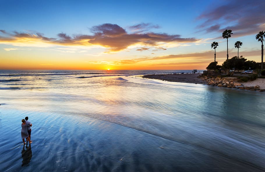 two person standing on water, man and woman standing on seashore during daytime HD wallpaper