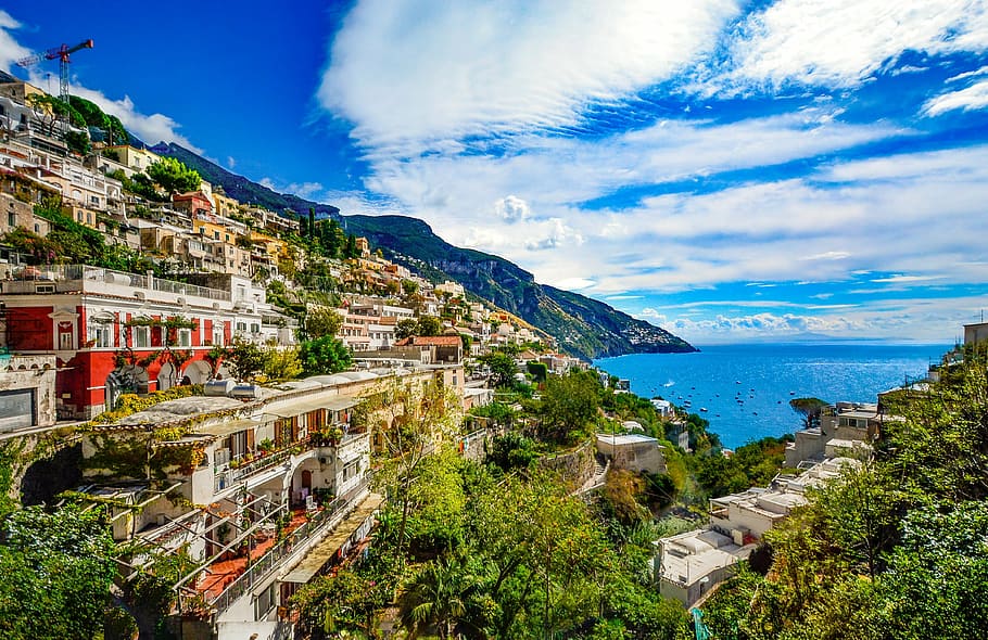village houses near body of water and mountains painting, amalfi coast