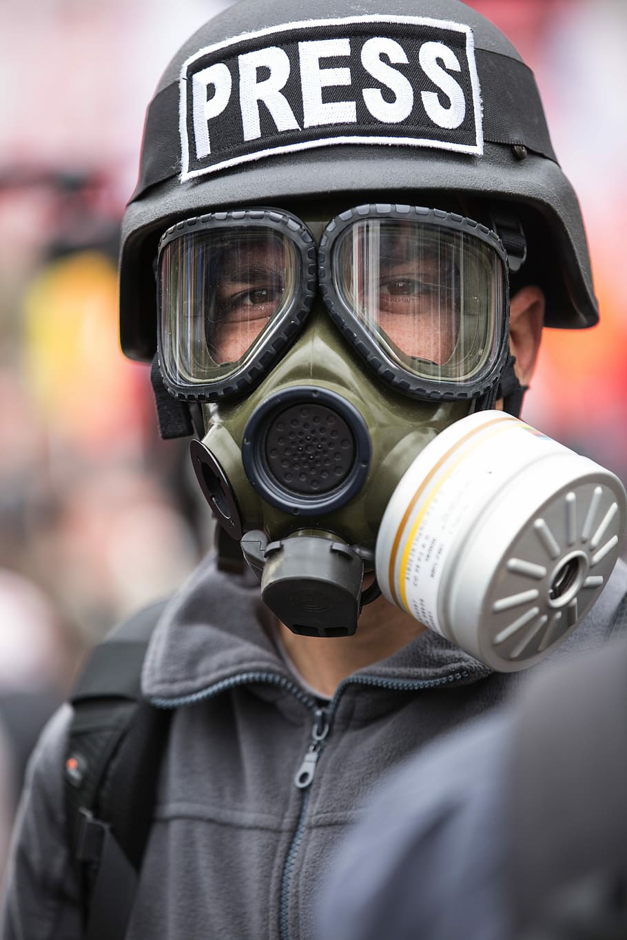 person wearing gas mask and black Press helmet, journalist, violence