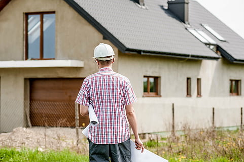 man standing in front of a concrete house, building, professional HD wallpaper