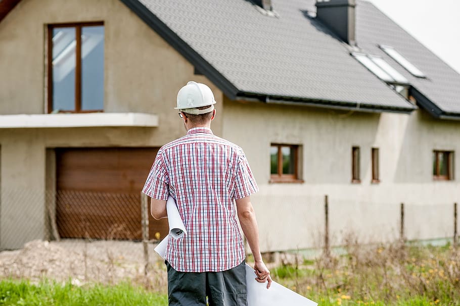 man standing in front of a concrete house, building, professional HD wallpaper