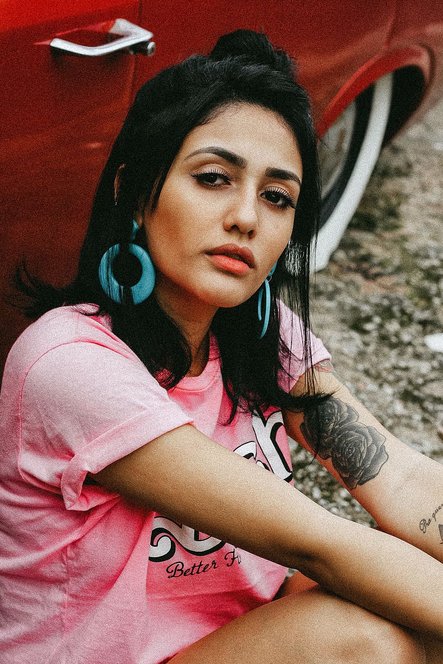 woman sitting beside red car, woman wearing pink shirt sitting beside red vehcile HD wallpaper