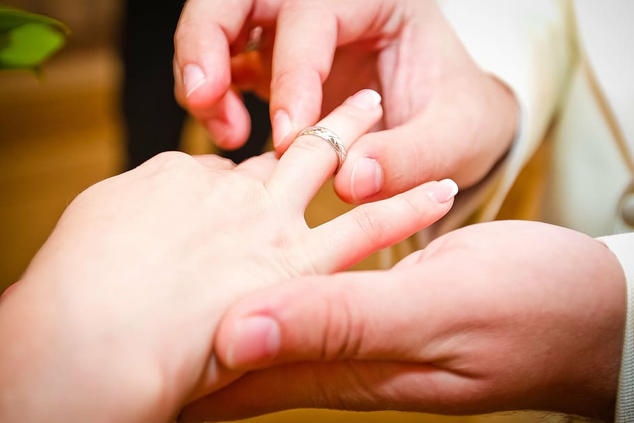 candid photography of man's hand wearing bridal ring on woman's finger HD wallpaper