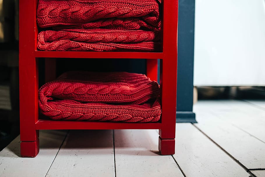 Folded sweaters and fabrics stacked on shelves, blanket, material HD wallpaper