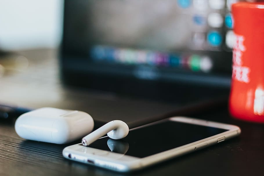 iPhone, AirPods on table, person showing silver iPhone with AirPods, HD wallpaper