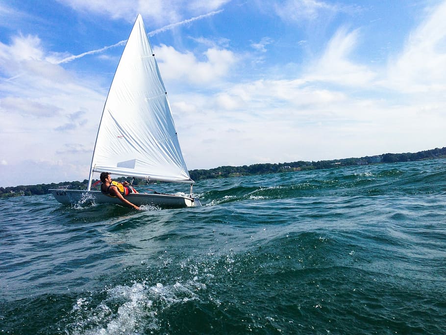 person riding boat under cloudy sky, person on white sailboat HD wallpaper