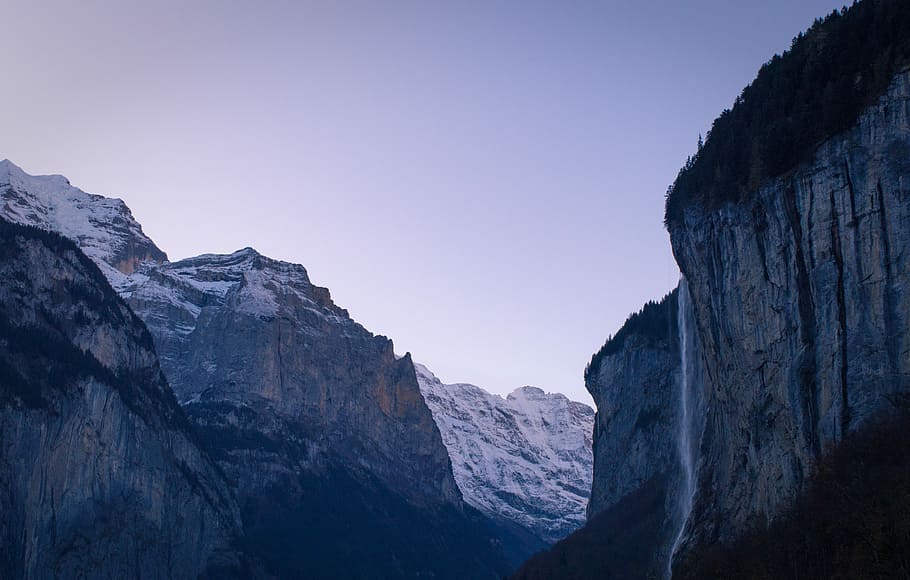 Blue hour over Lauterbrunnen, rocky cliff with waterfall, mountain