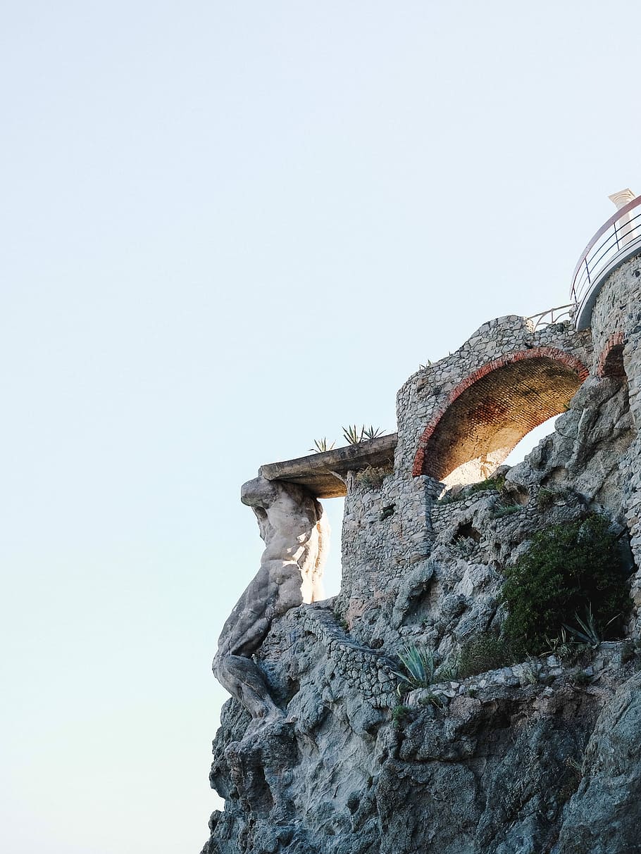 stone structure near cliff, brown concrete stone bridge near cliff during daytime HD wallpaper