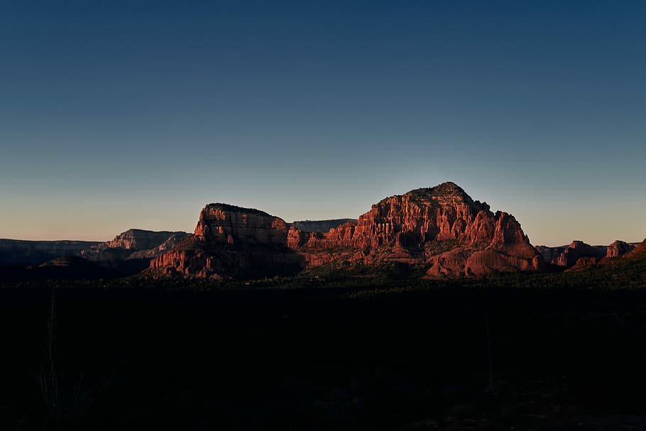 cliff under blue sky, photography of brown mountain range during daytime HD wallpaper