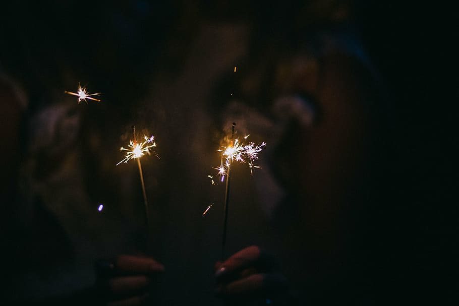 person holding two sparklers, firecrackers, sparkling, light HD wallpaper