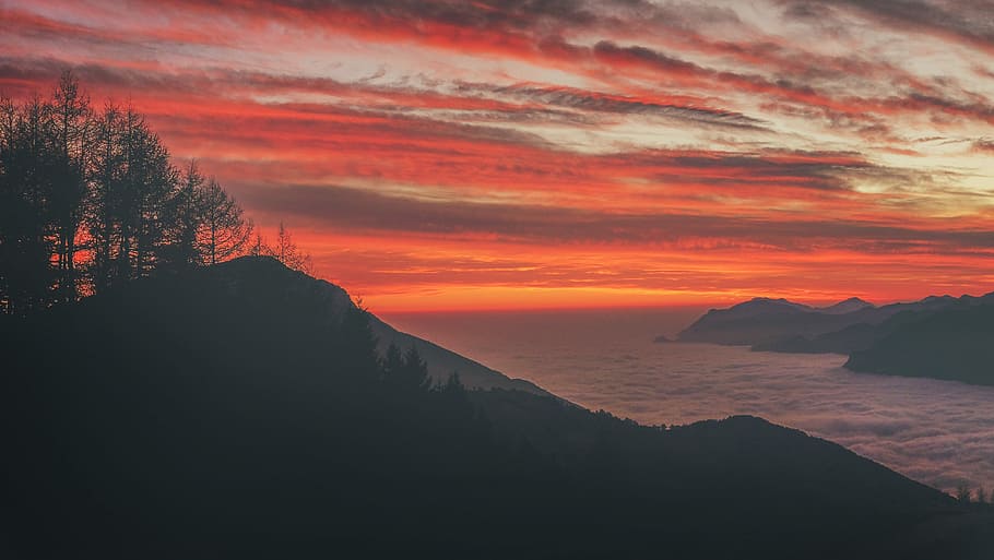 silhouette photo of mountain near body of water during sunset, body of water between mountains in sunset HD wallpaper