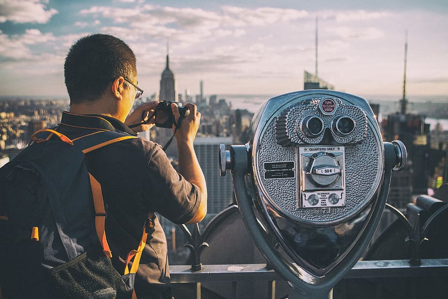 A tourist takes a picture with his camera on the Top Of The Rock observation deck at the famous Rockefeller Center, Manhattan, New York City, HD wallpaper
