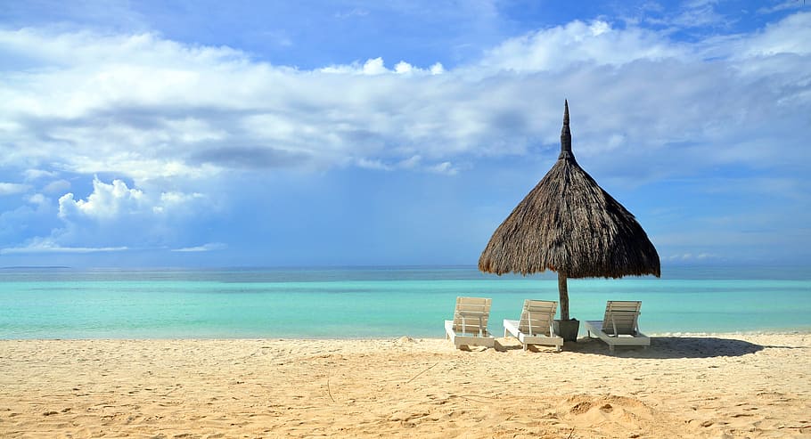 black hut covering white Adirondack chairs in front of beach HD wallpaper