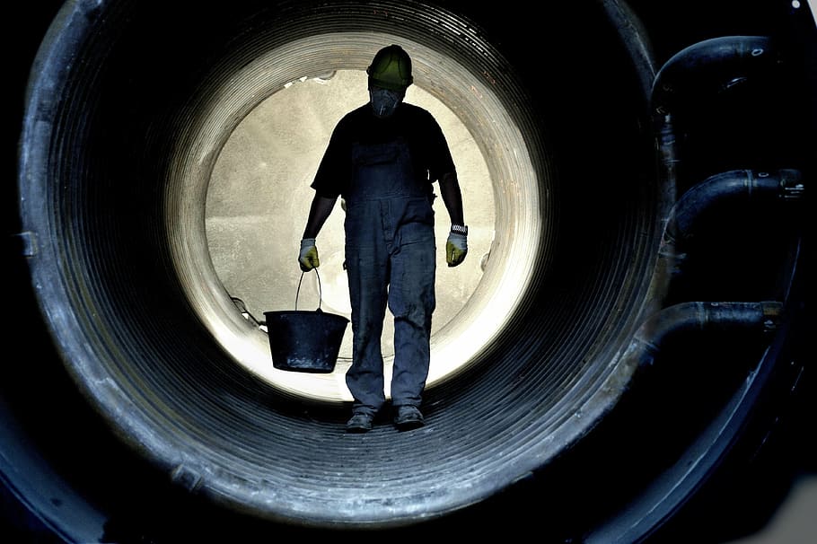 man carry black bucket inside black pipe, workers, production HD wallpaper