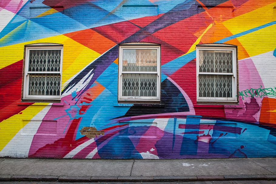 Wide angle shot of a brick building in East London that is covered in brightly coloured street art. Image captured with a Canon DSLR, HD wallpaper