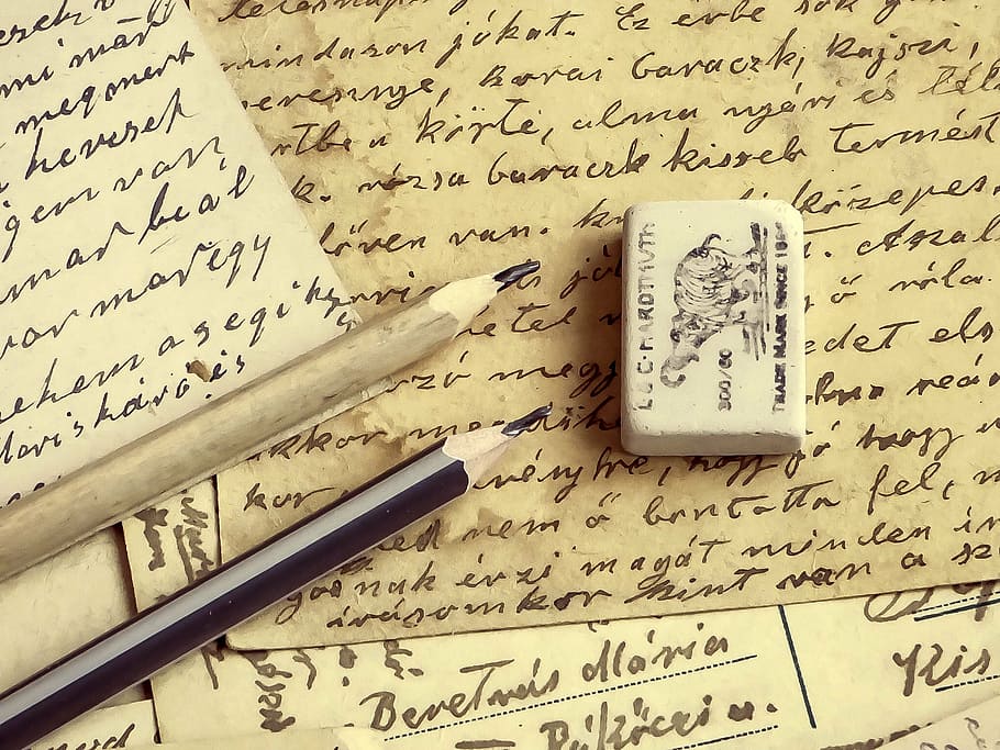 twp brown and black pencils and one eraser on beige printing paper HD wallpaper