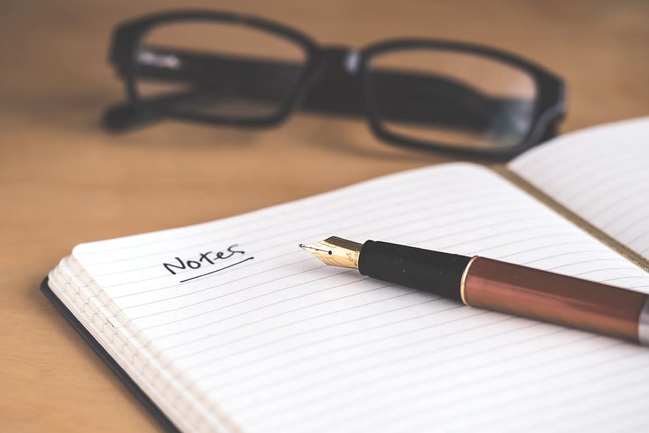 brown fountain pen on notebook, black framed eyeglasses above notebook with pen HD wallpaper