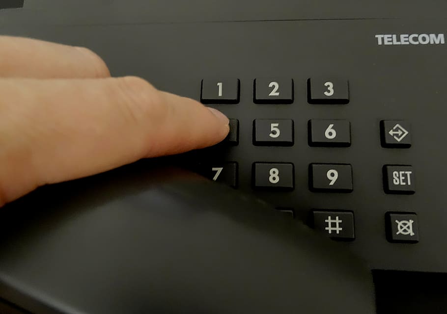 person dialing on black Telecom telephone, select, tap, enter HD wallpaper