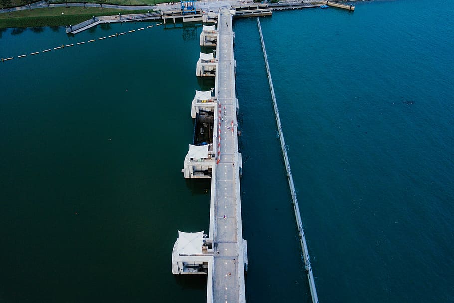 aerial photography of concrete bridge over blue body of water, aerial view of bridge over body of water HD wallpaper