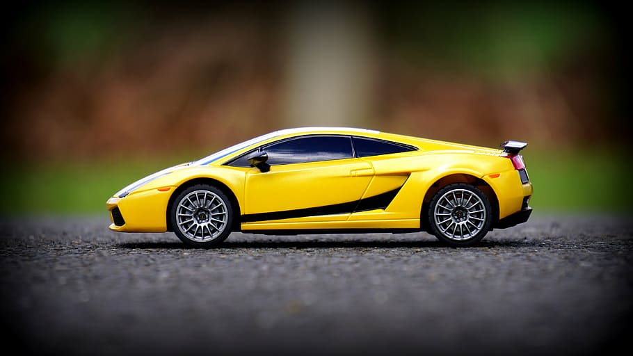 HD wallpaper: focus photo of yellow Lamborghini Gallardo scale model on  gray concrete pavement | Wallpaper Flare