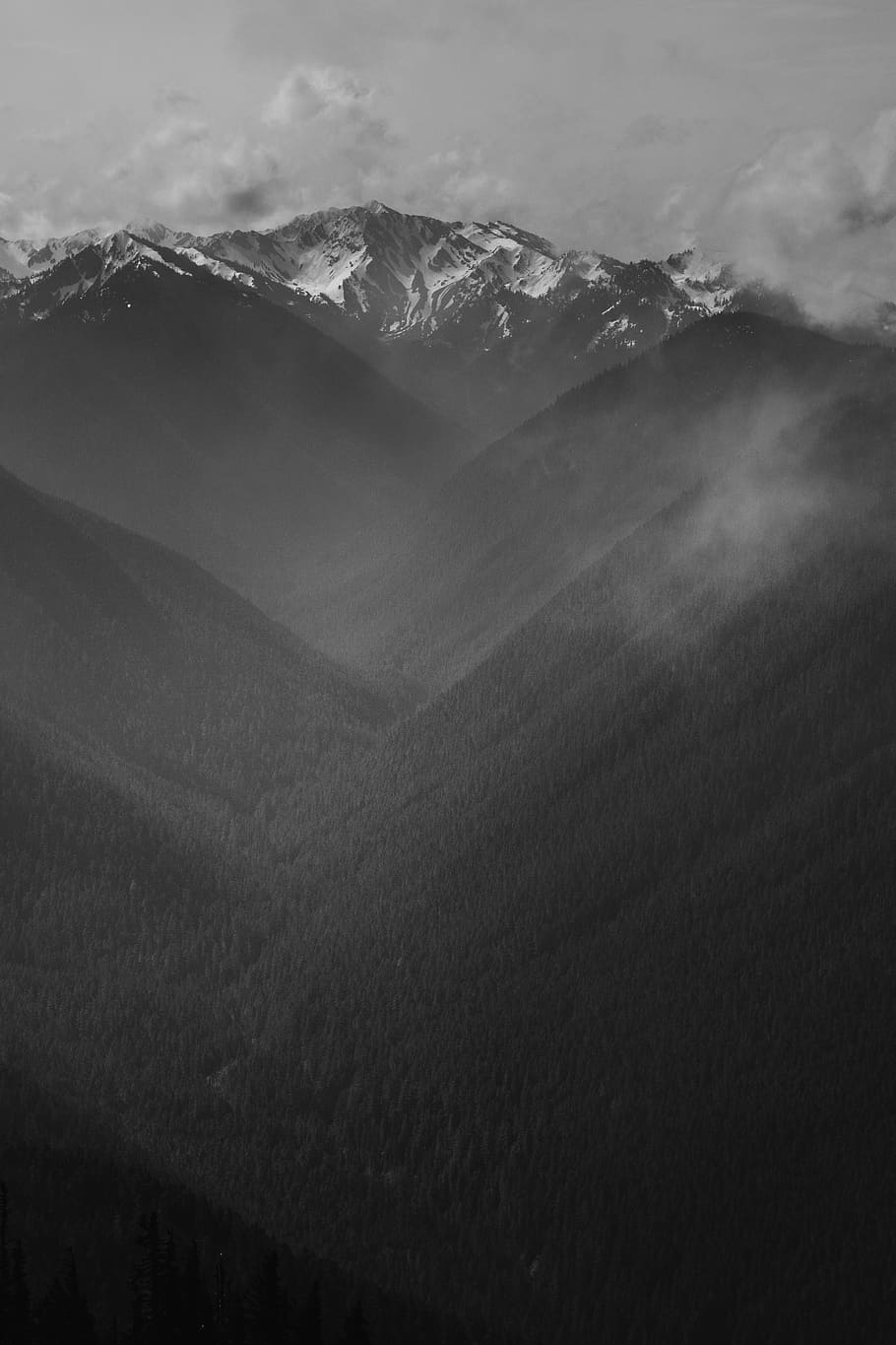 grayscale photo of mountain range, cloudy sky on top of mountain HD wallpaper
