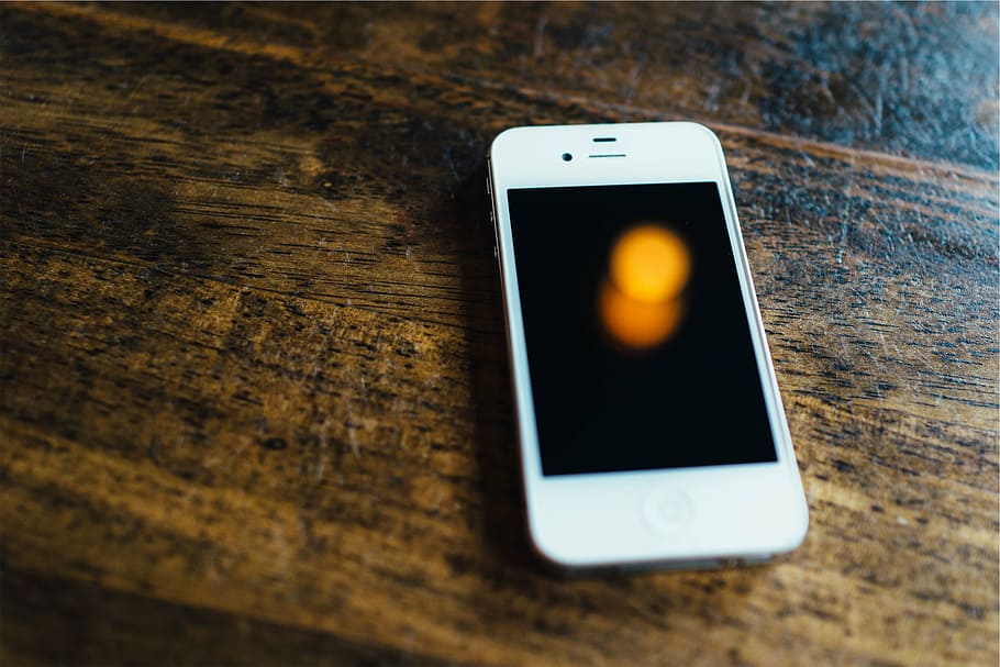 white iPhone 4 on brown wooden panel, photo, surface, cell HD wallpaper
