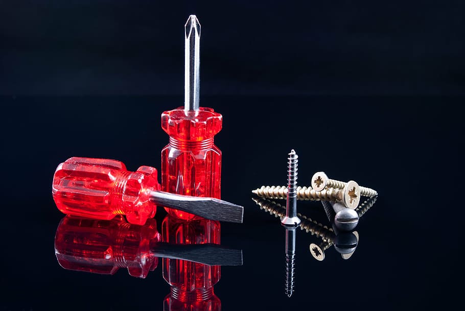 photo of two red screwdrivers, screws, black, tools, work, repair