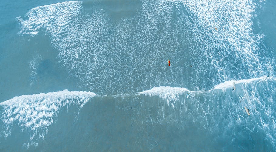 aerial photography of barrel wave, top view of body of water