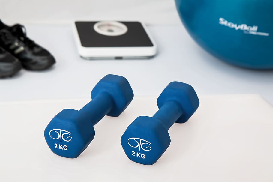 two 2 kg. vinyl dumbbells on white surface, blue, TC, physiotherapy