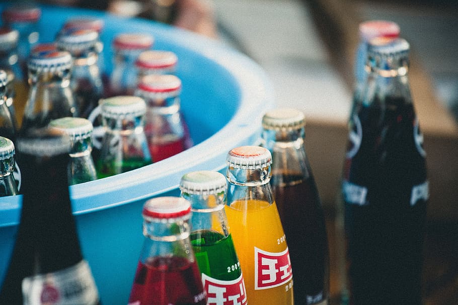 closeup of soda bottles beside basin, multicolored soda bottles HD wallpaper