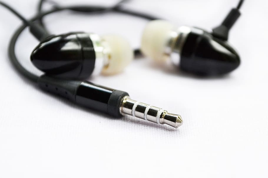 selective close-up photo of black and white canalbuds, Headset
