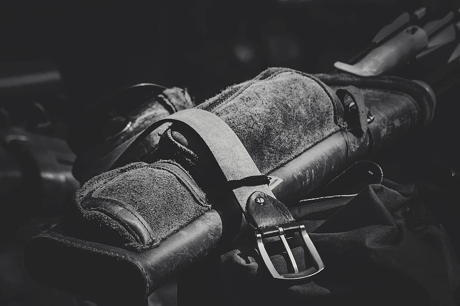 grayscale photo of black bag, leather, belt, white, black and white