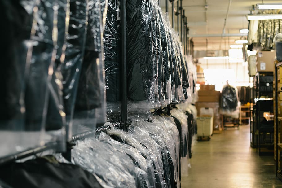 black suit hanging on rack, black steel rack, warehouse, store