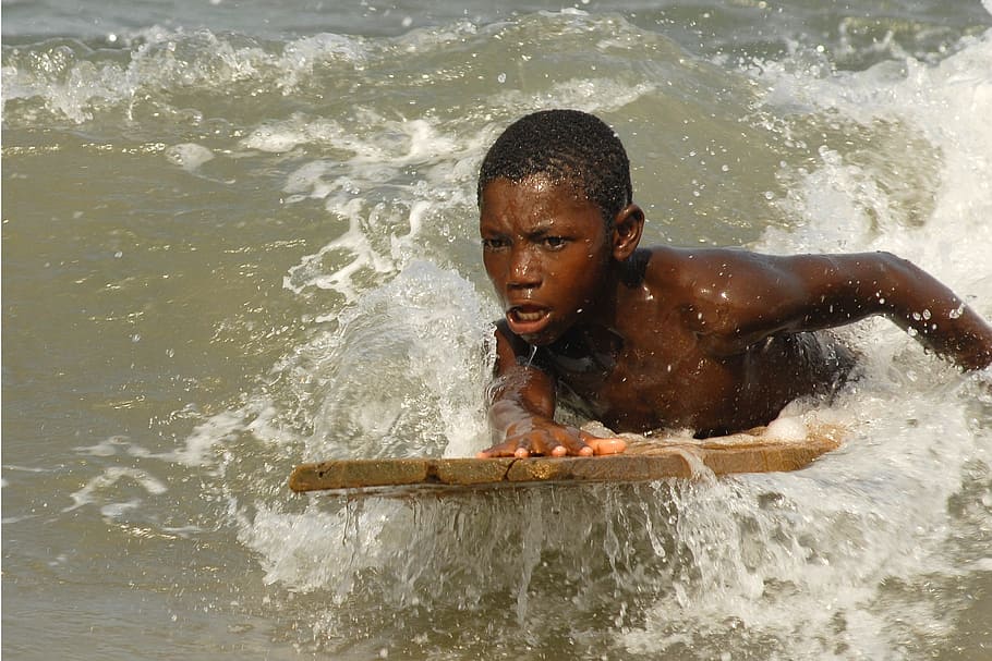 boy riding brown board on wave, ghana, sea, surfer, water, motion, HD wallpaper