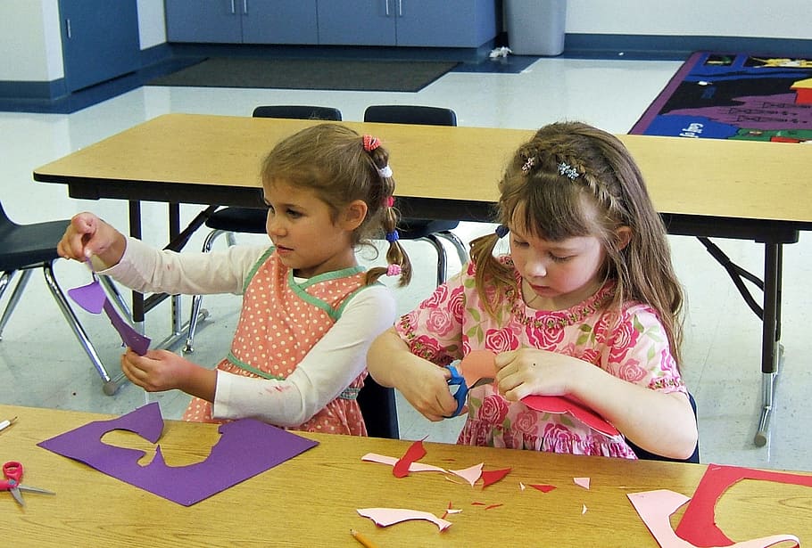 two girls cutting purple papers in front of brown table, classroom HD wallpaper