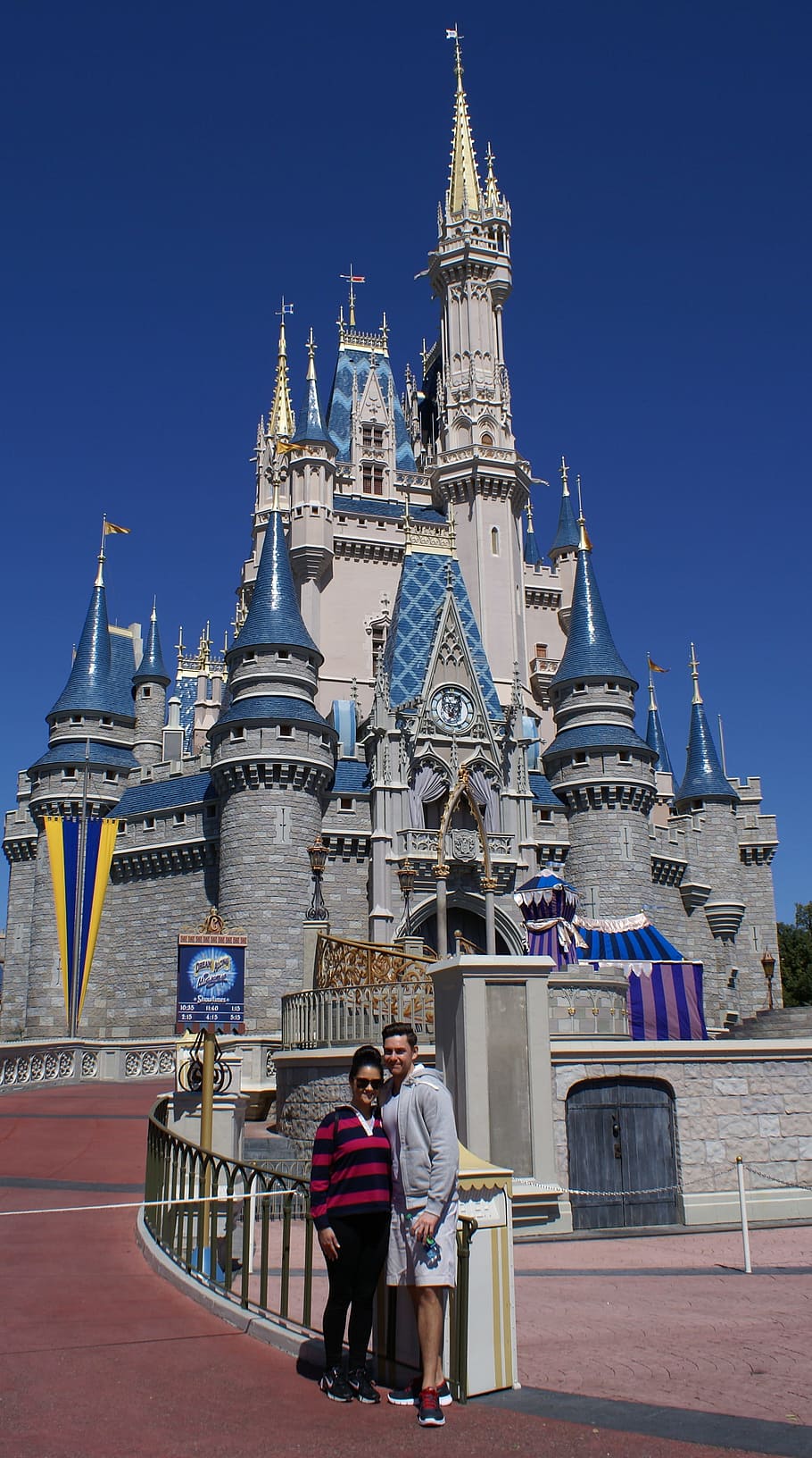 man and woman taking picture infront of Walt Disney castle, Florida