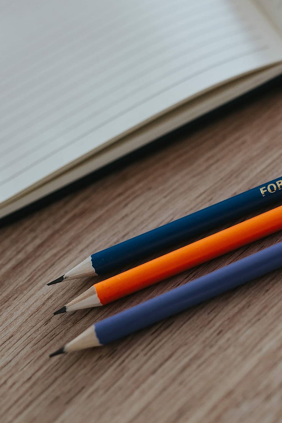 Notebooks with colourful pencils on a wooden desk, copy space HD wallpaper