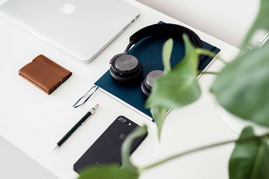 headphone on top of notebook on white table, apple, mobile HD wallpaper