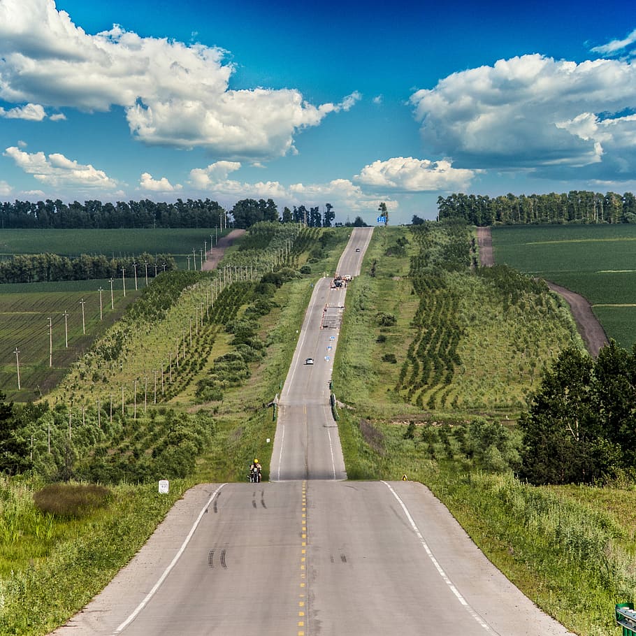 The beautiful mountain road, aerial view of asphalt road between green trees HD wallpaper