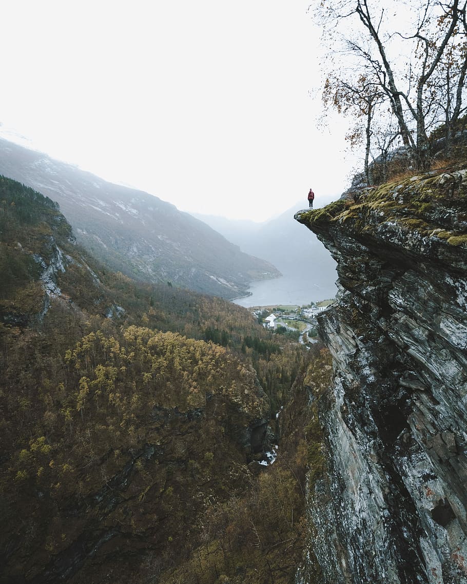 Moody view, person standing on top of the cliff, mountain, rock HD wallpaper